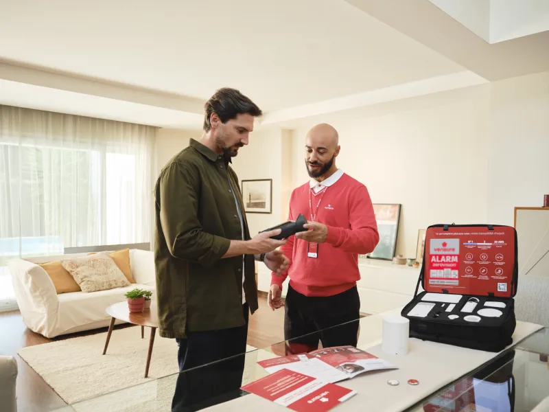 Verisure security specialist installing and testing an alarm system