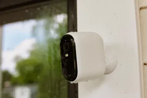 Verisure outdoor security camera being fitted on a property, rated for use in the rain