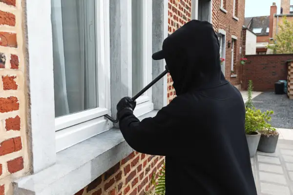 Burglar attempting to break in via a window