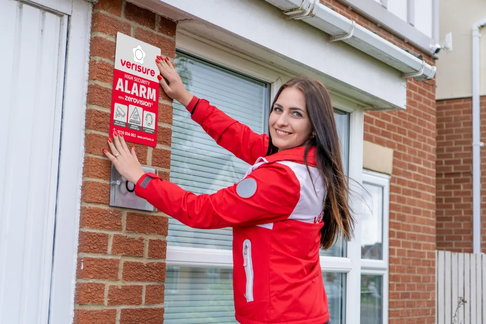 Deterrent sign being installed by Verisure Employee