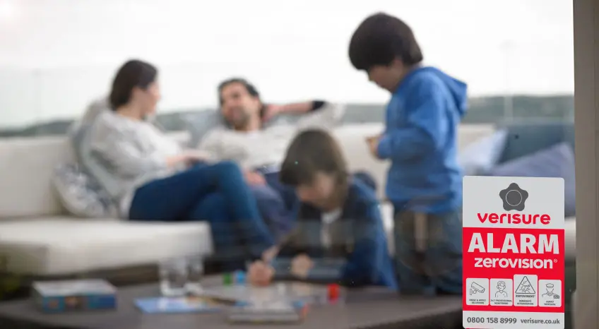 Verisure deterrent signs on a window of a family home