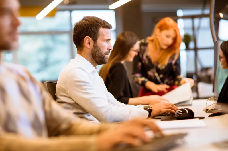 Young business people working in a busy office